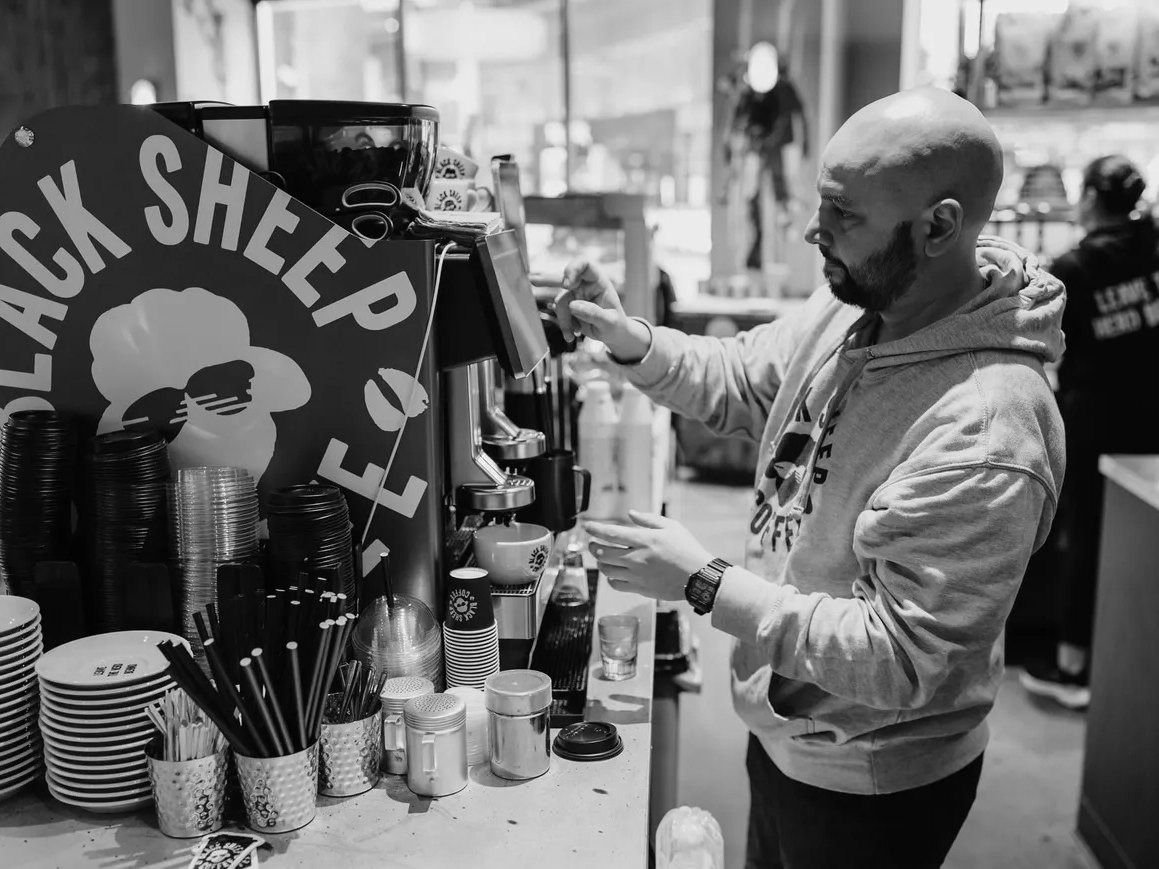 Making coffee behind the bar at Black Sheep Coffee